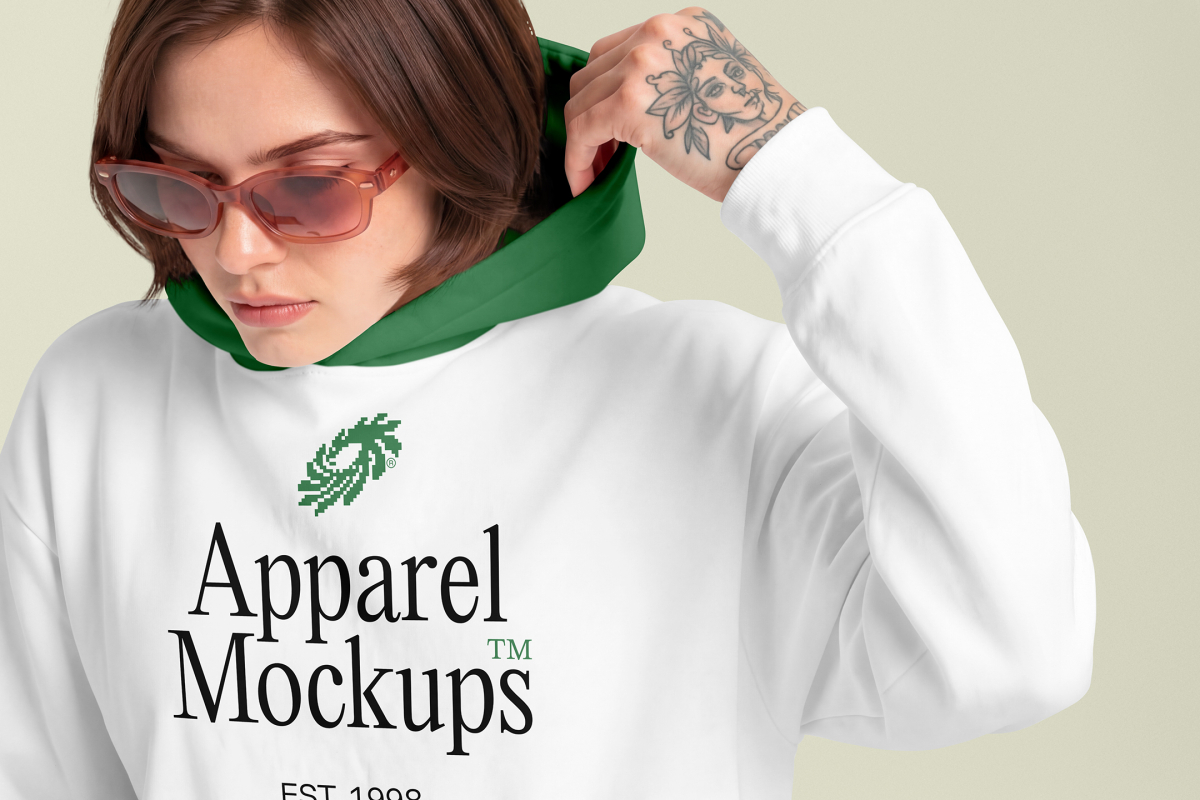 Front view of a female model wearing a white hoodie mockup standing against the bright studio background from the studio apparel mockups product.