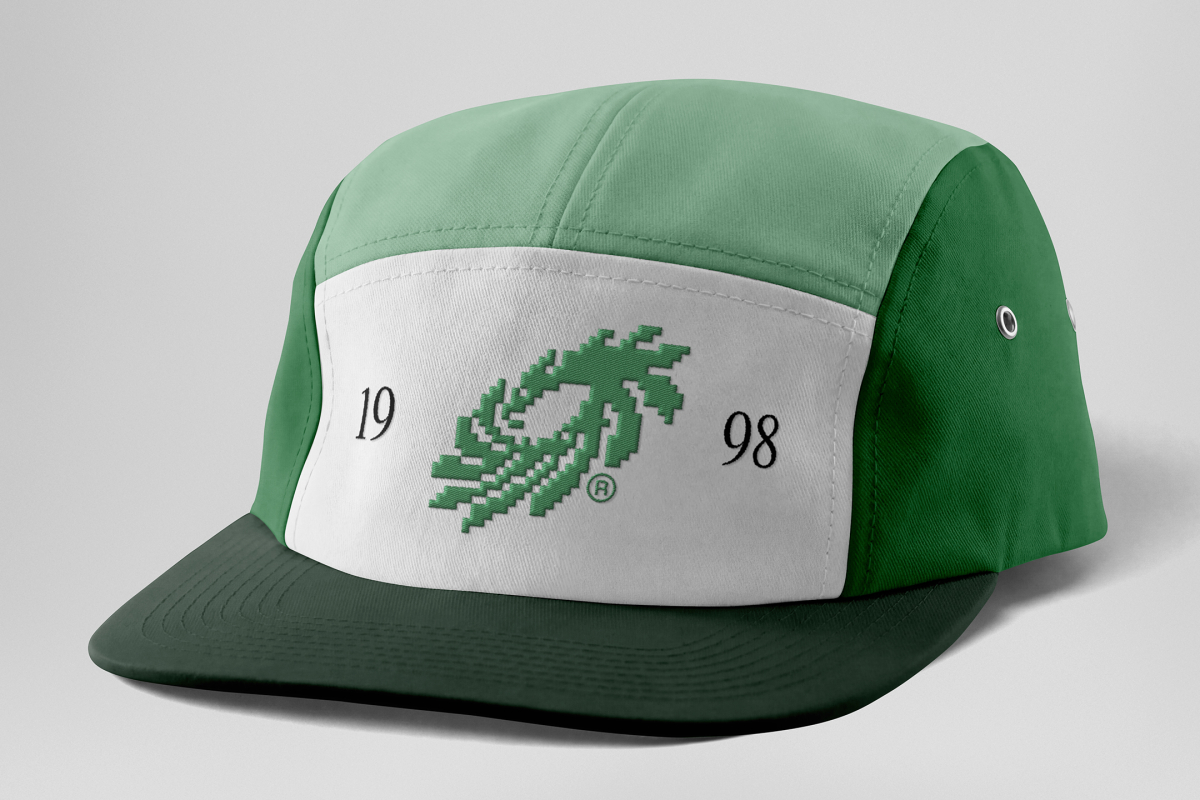 Front view, lying five panel cap mockup in three shades of green and white colors with black typography design and green logo on the grey studio background from the studio apparel mockups product.