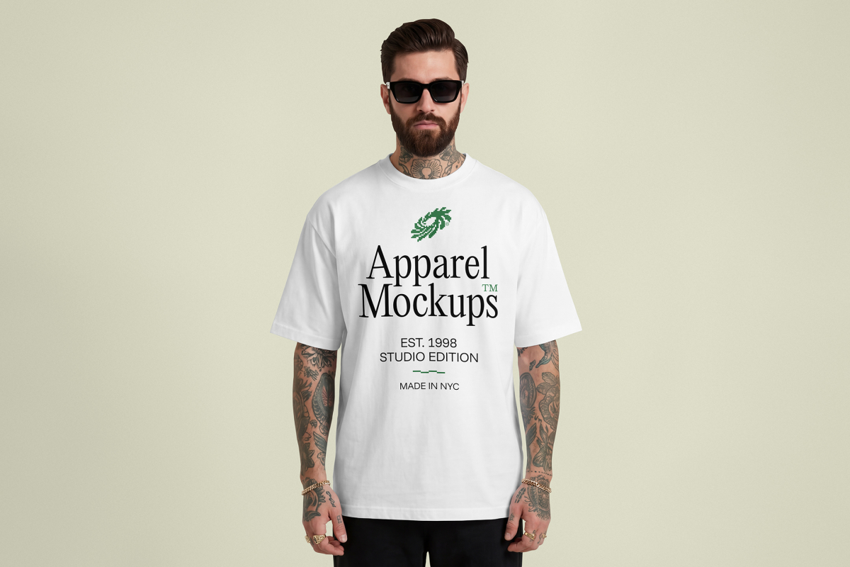 Front view of a male model wearing a white t-shirt mockup with a black typography design standing against a bright studio background from the studio apparel mockups product.