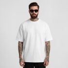 Front view of a male model wearing a white t-shirt mockup standing against a white studio background from the studio apparel mockups product.