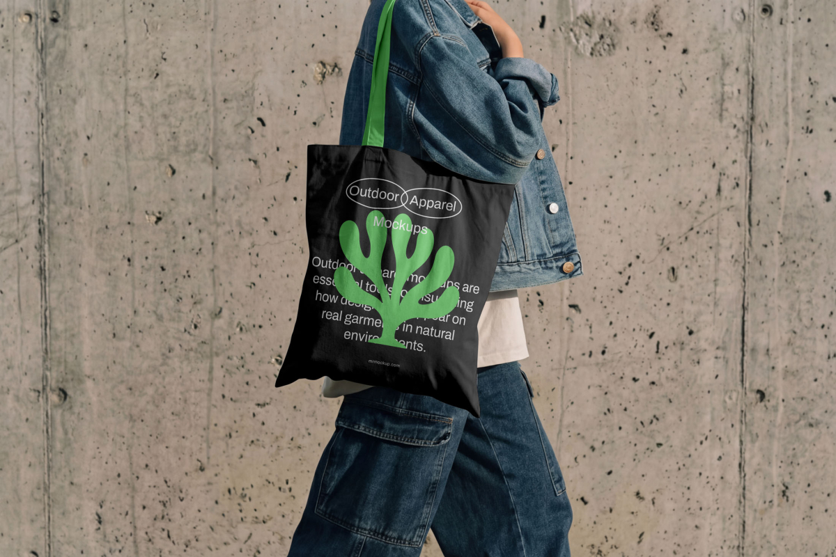 Front view, male model wearing a black canvas bag mockup with a simple geometric typography logo from the Outdoor Apparel Mockups Vol.3 product.