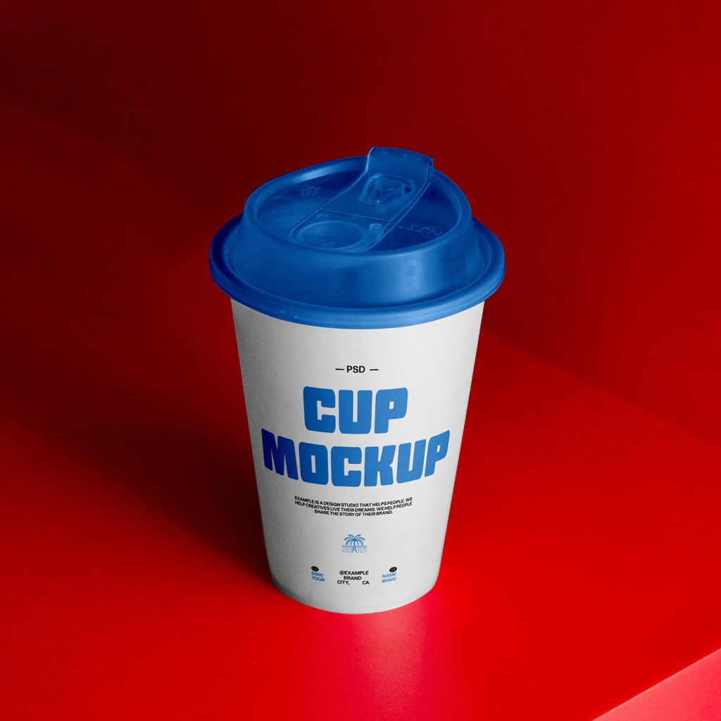 Front view coffee cup mockup in white and blue color and typography design standing on the red shelf.