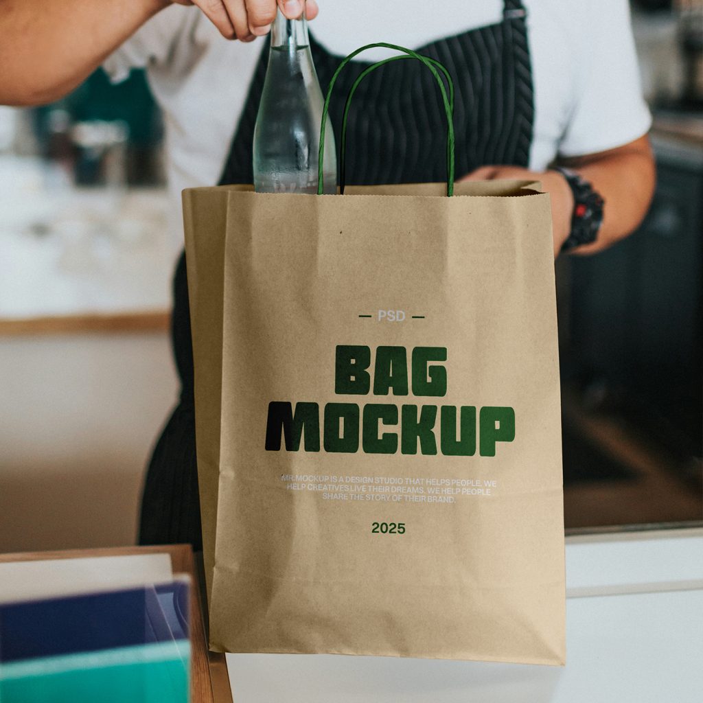 Front view craft shopping bag mockup with green and white typography design used by men in the shop.