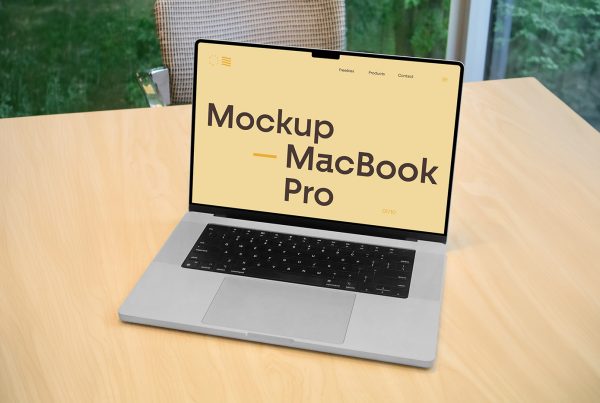Front view MacBook Pro mockup with typography design on the screen standing on the wooden desk in the office.