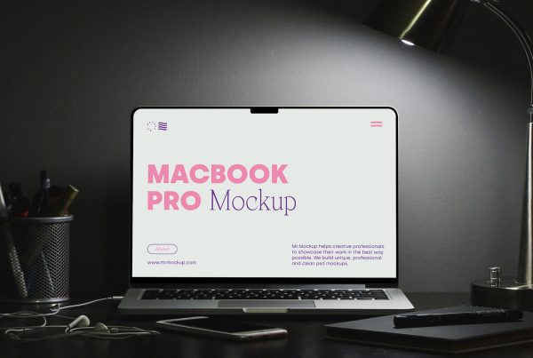 Front view MacBook Pro mockup with typography design on the screen lying on the black desk.