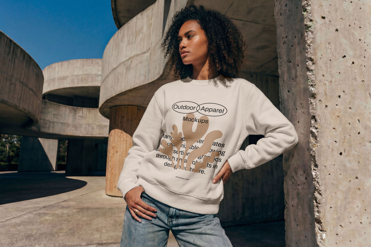 Standing female model wearing a blue sweatshirt mockup from the Outdoor Apparel Mockups Vol.3 product.