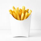 A white paper french fry scoop filled with golden, crispy french fries, set against a clean, minimalist white wall and surface.