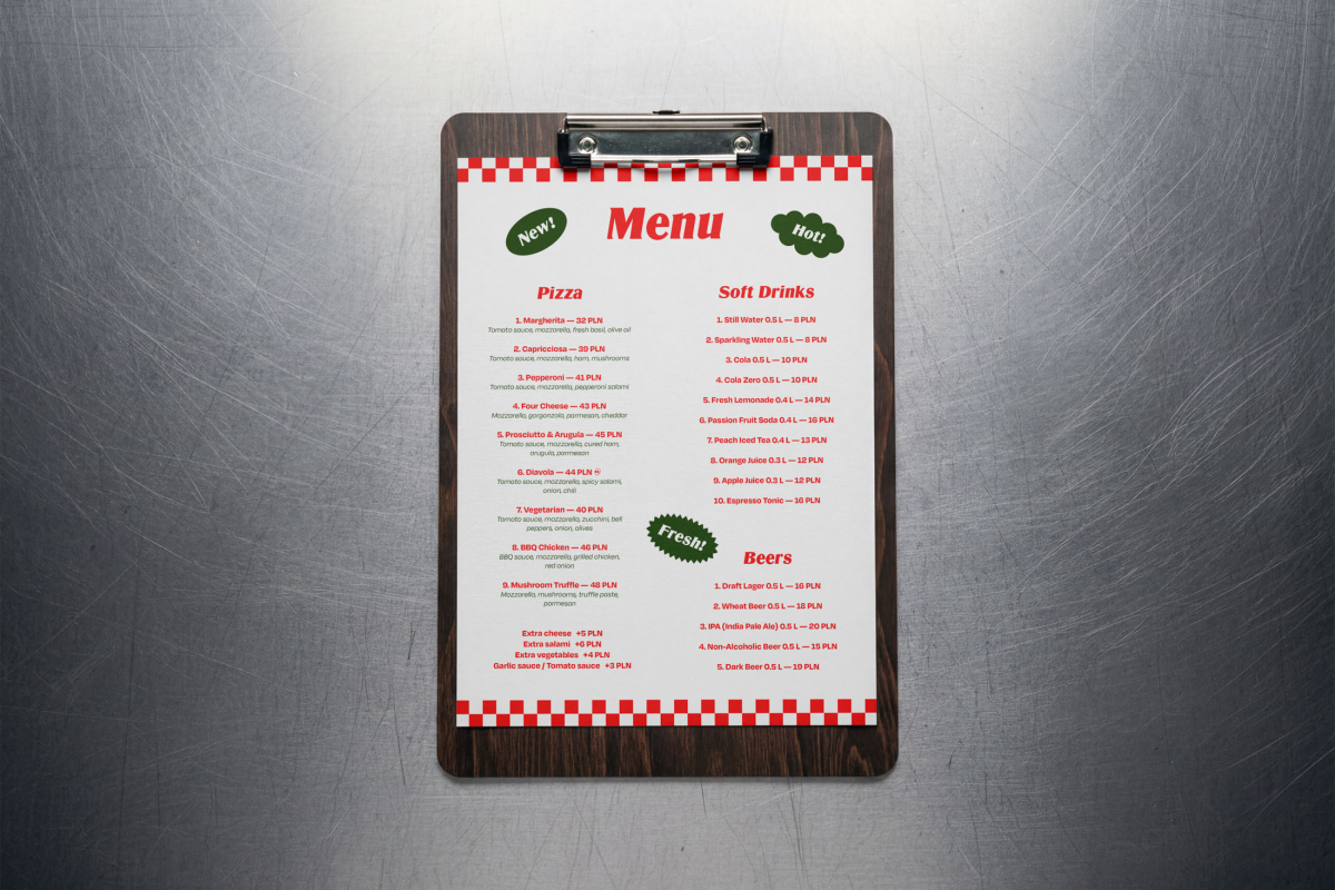 A wooden clipboard holding a printed restaurant menu, placed flat on a scratched metallic surface. The menu is styled with red checkered borders, green promotional badges, and lists options and prices for pizzas, soft drinks, and beers.