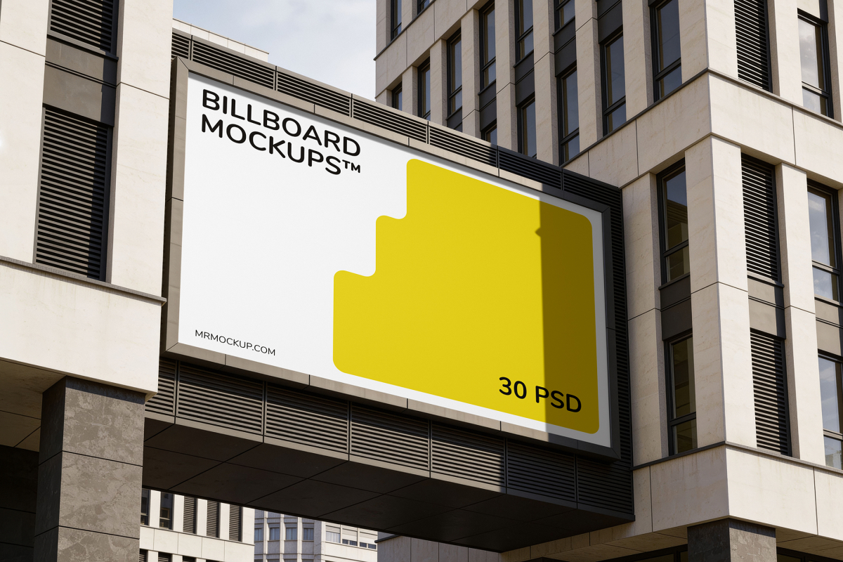 Wide horizontal billboard mounted on an elevated walkway bridge connecting two modern glass and stone office buildings.