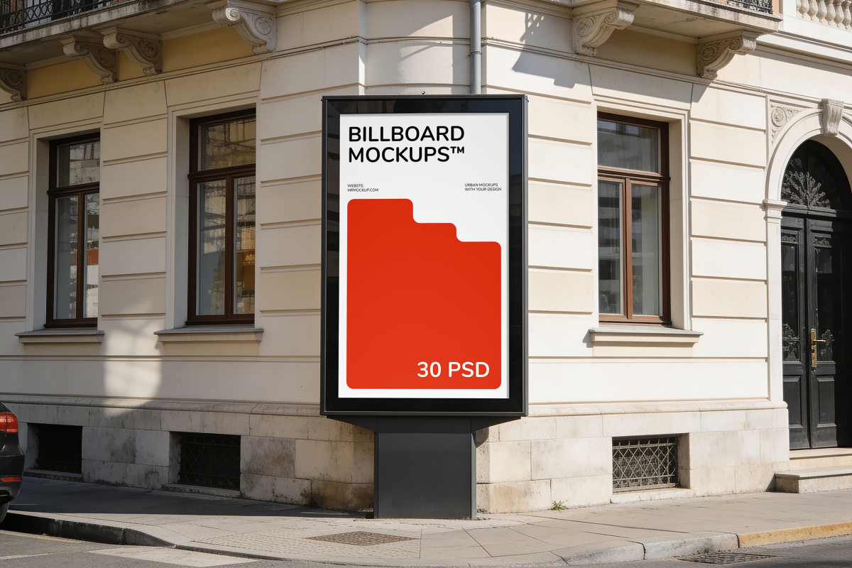 Freestanding vertical city light poster display on a street corner against the facade of a classic residential building.