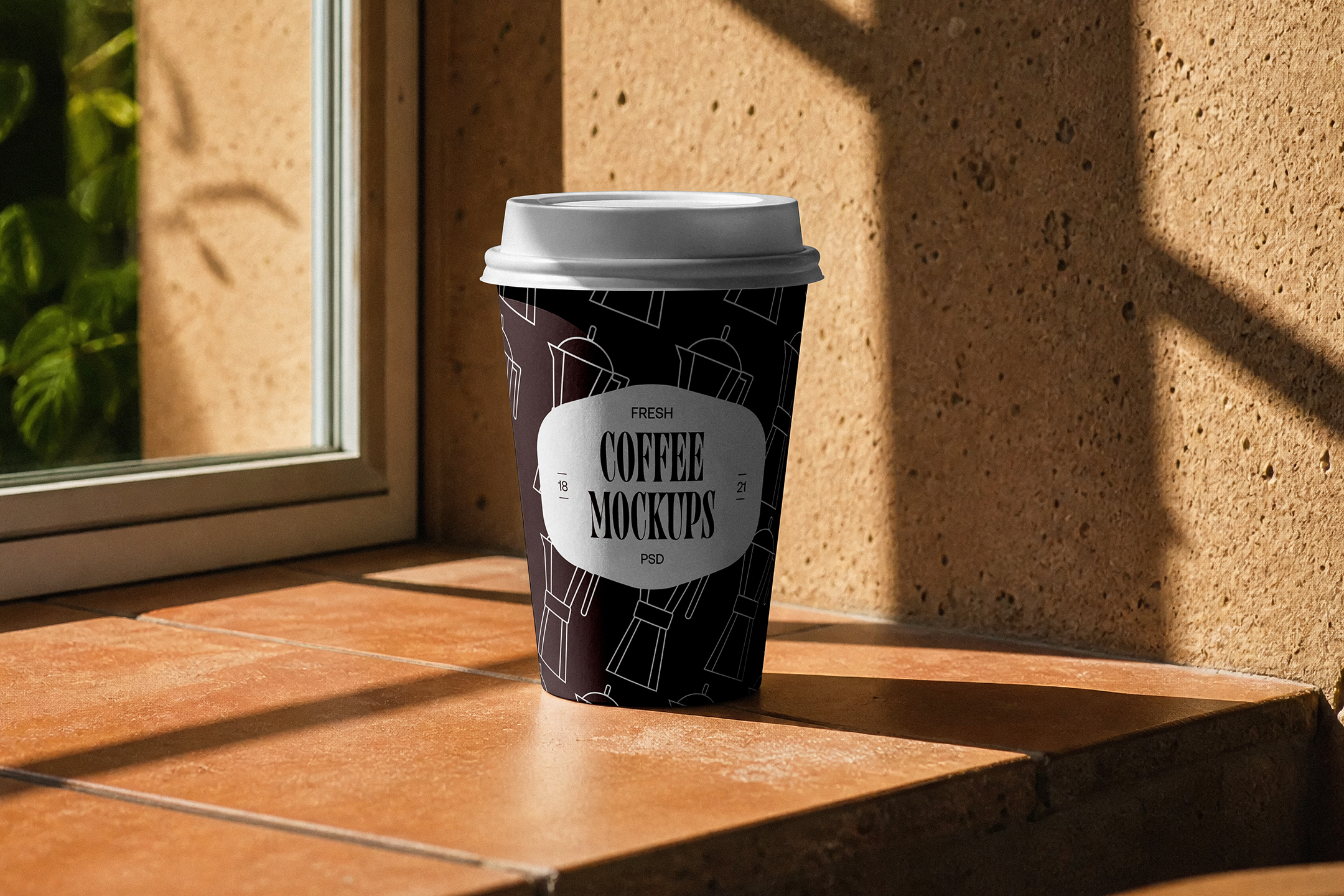 Take-Away-Coffee-Cup-Mockup-02-CMV2-A A dark brown paper coffee cup with a white lid resting on a terracotta tiled windowsill under warm sunlight and foliage shadows.