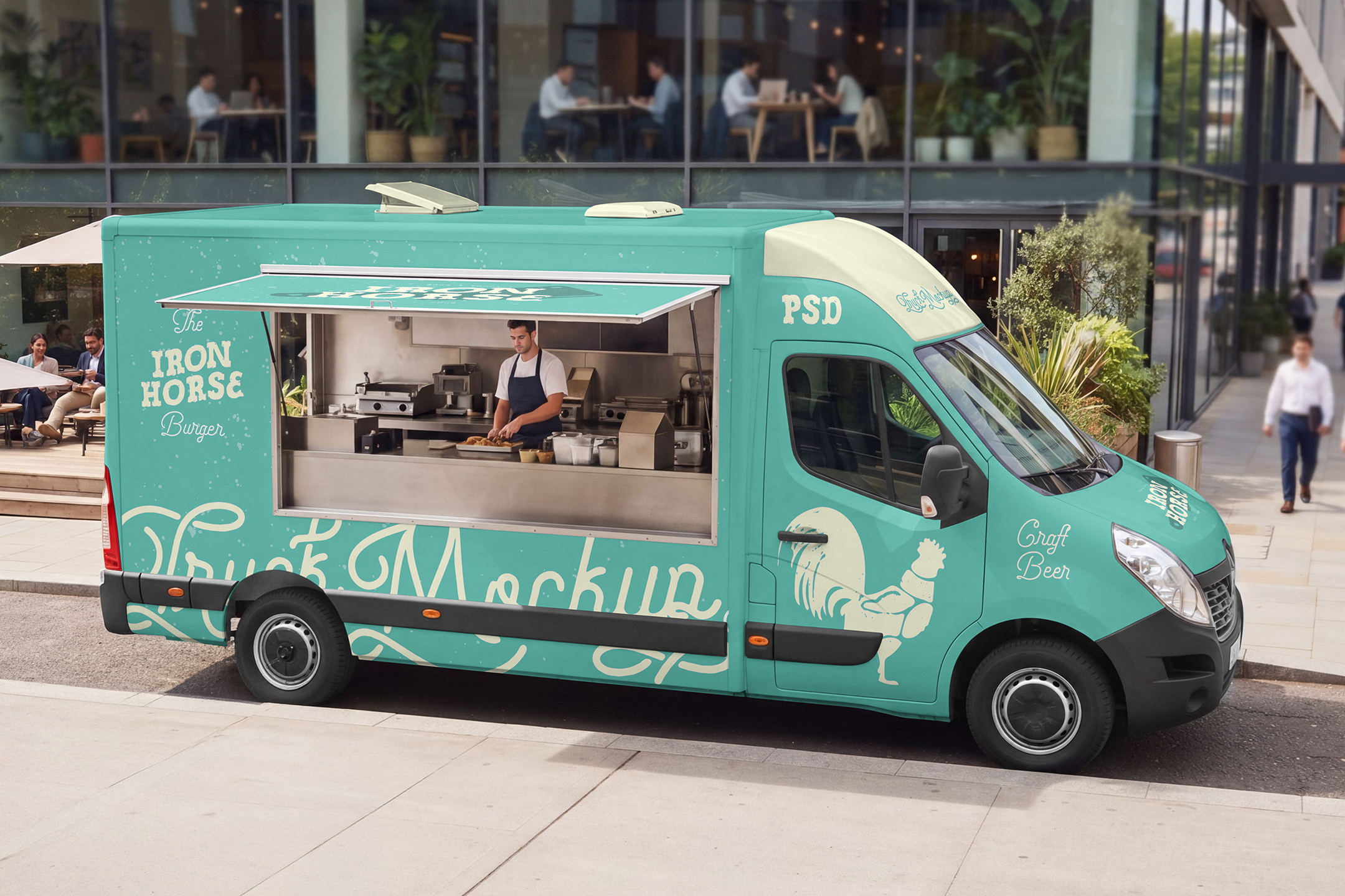 Food-Truck-Mockup-02-FTM-A High-angle view of a turquoise food truck mockup with an open service window and a chef preparing burgers inside, parked along an urban street near a modern office building.