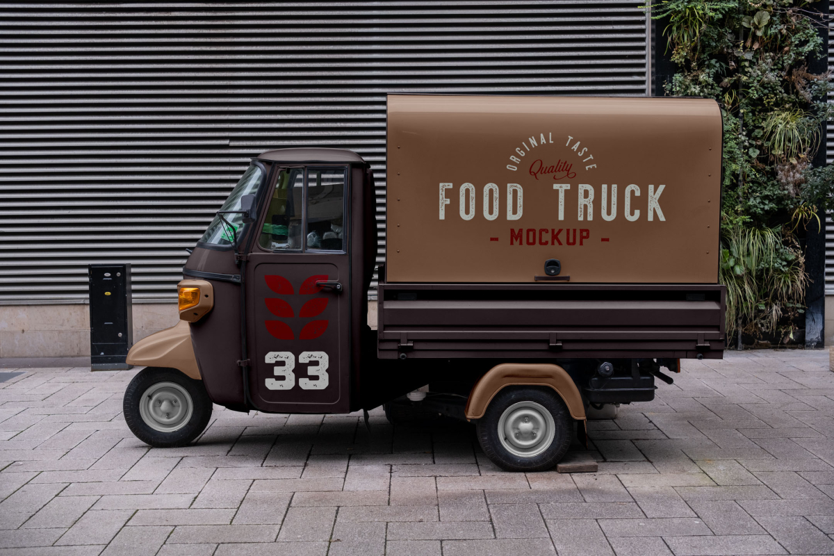 Side view of a vintage brown and beige Piaggio Ape food truck mockup parked against a modern slatted wall background.