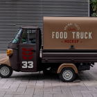 Side view of a vintage brown and beige Piaggio Ape food truck mockup parked against a modern slatted wall background.