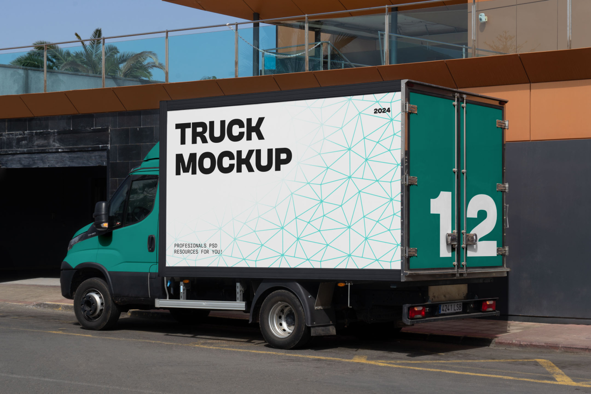 Three-quarter side view of a teal delivery box truck with a white cargo box and teal rear doors featuring a large number 12.