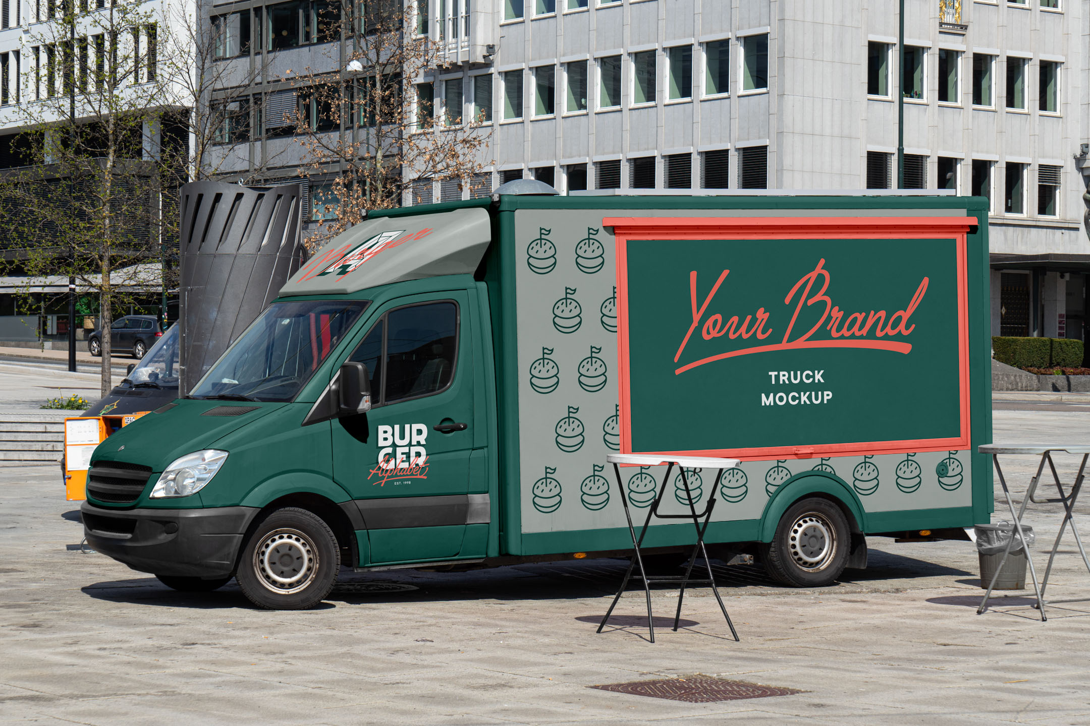 Street-Food-Truck-Mockup-A Side profile of a dark green Mercedes Sprinter food truck mockup with red framing and burger icons, parked in an open city plaza.