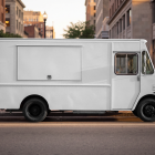 Side profile of a white step van food truck mockup with closed hatch parked along a city curb during golden hour.