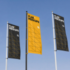 Three vertical flag banners in black and yellow were hoisted on flagpoles against a clear blue sky.