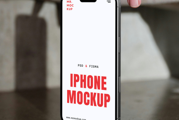 A close-up front-view shot of an iPhone featuring a blank, bright white screen with a Dynamic Island notch. The phone is supported upright against a textured grey concrete surface, with a person's fingers lightly holding the top edge, creating soft ambient shadows around the device. Free Front View Mobile Mockup
