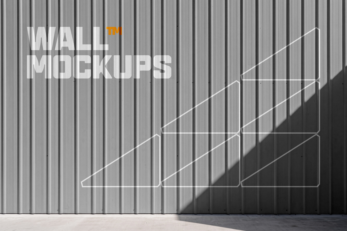 Corrugated grey metal wall paneling with line graphics under direct sunlight and shadow.