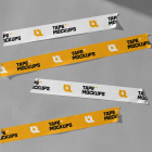 Four strips of yellow and white printed tape stuck horizontally on a textured grey background.