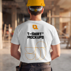 Back view of a construction worker wearing a yellow safety hard hat and printed white t-shirt indoors.