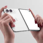 Hands holding a partially folded smartphone from the back, displaying the white rear panel, dual cameras, and a blank cover screen.