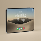 Side view of an unfolded silver foldable smartphone standing horizontally on a beige background, displaying a desert landscape wallpaper.