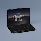 Three-quarter angle view of an open dark foldable smartphone bent in a laptop position, displaying 'iPhone Duo Mockup' text on top and a calendar grid below.