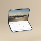 Floating high-angle view of a silver foldable smartphone open in L-shape, displaying a desert landscape wallpaper on top and a clean calendar screen on the bottom section.